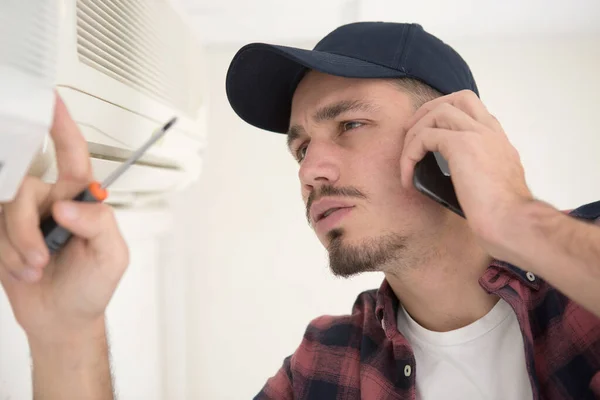Junger Handwerker Repariert Klimaanlage Und Ruft Hilfe — Stockfoto