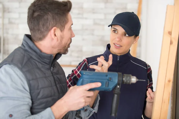 Male Female Workers Discussion Man Holding Drill — Stock Photo, Image
