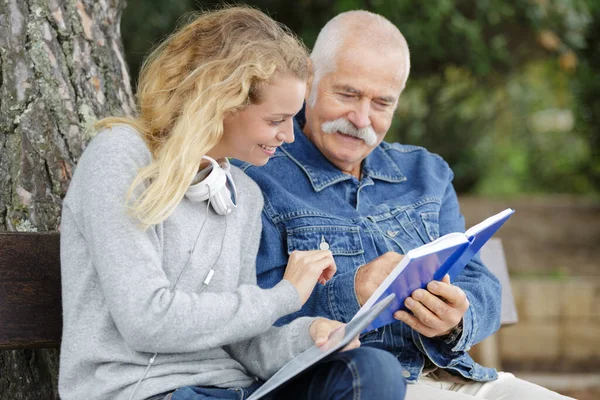 Elderly Man Young Woman Looking Book Outdoors — Stock Photo, Image