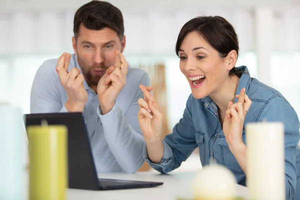 Couple Looking Laptop Fingers Crossed Anticipation — Stock Photo, Image