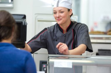 portrait of smiling female seller in local butchery clipart