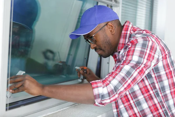 man during window maintenance service