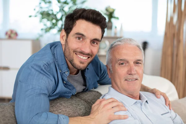 Smiling Grown Son Sit Couch Relax Senior Dad — Stock Photo, Image