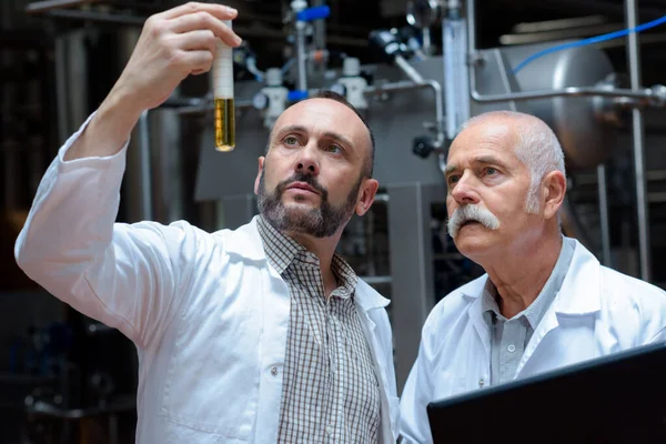 Two Men Lab Coat Looking Beaker Beer — Stock Photo, Image