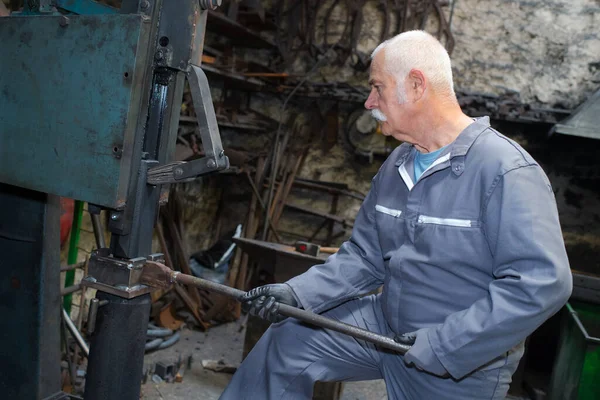 Senior Blacksmith Tending Equipment — Stock Photo, Image