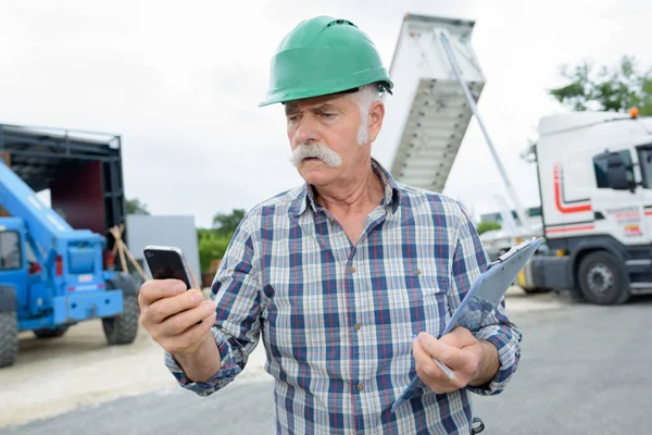 Senior Man Using Smartphone Tipper Lorry Unloading Background — Stock Photo, Image