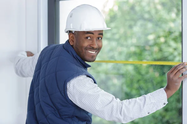 male worker measure the window