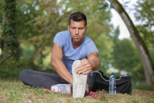 Fit Man Stretching Legs Outdoors — Stock Photo, Image