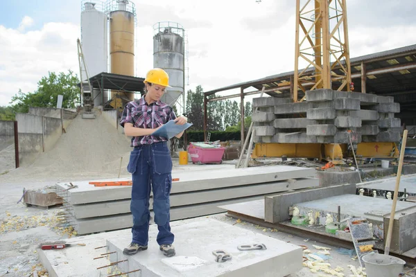 woman architect supervising building construction site