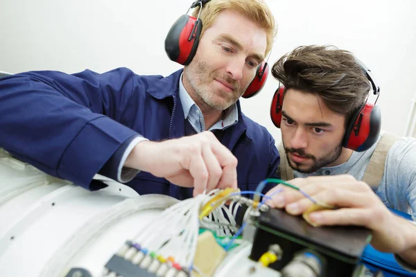 Technicians Maintaining Record Rack Mounted Server Stock Image