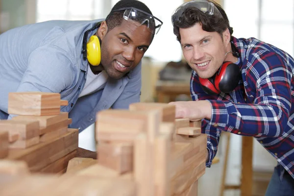 two male workers working in furniture industry
