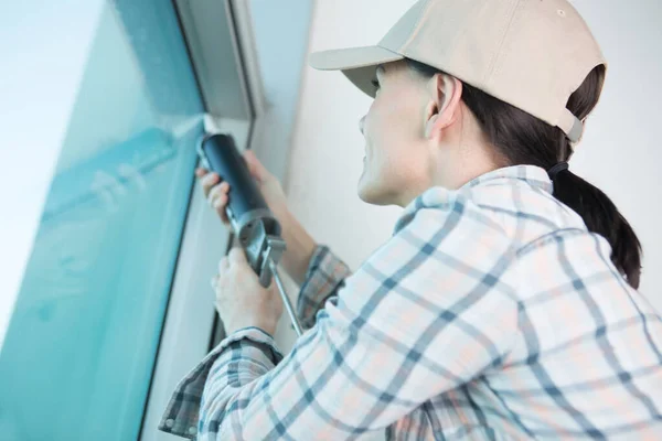 Concentrated Woman Applying Silicone Window — Stock Photo, Image