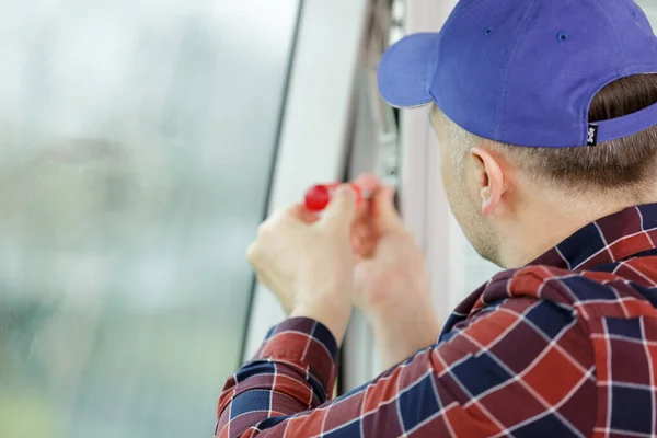 ドライバー付きの窓を設置するサービスマン — ストック写真