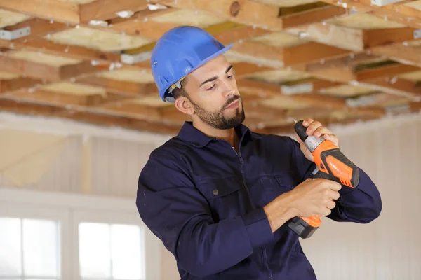 Young Man Builder Adjusting Cordless Drill — Stock Photo, Image