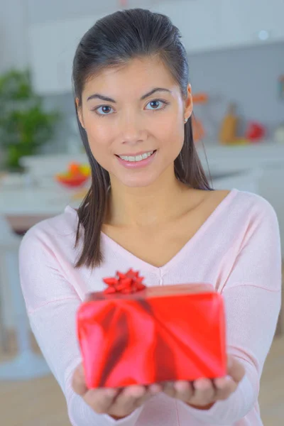 Studio Shot Young Eurasian Woman Offering Gift — Stock Photo, Image