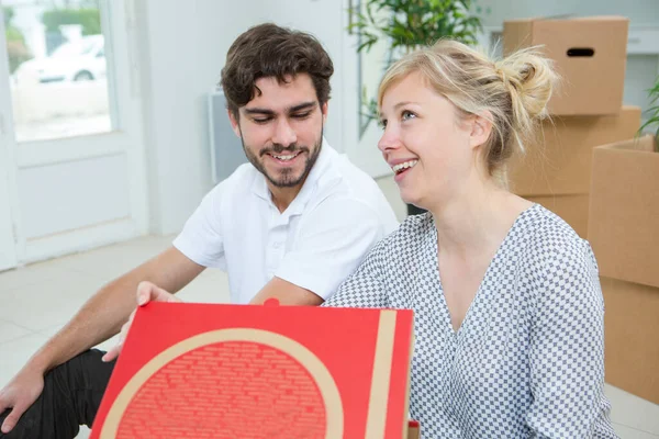 Couple Eating Pizza Next Moving Boxes — Stock Photo, Image