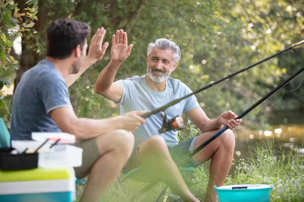 クールなお父さんと息子の湖で釣り — ストック写真