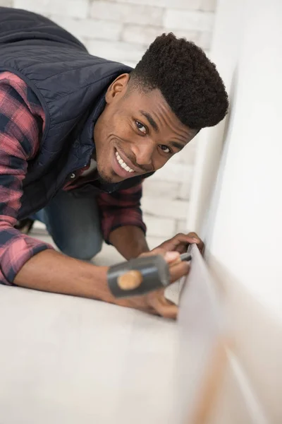Young Man Laying Floor Panels — Stock Photo, Image
