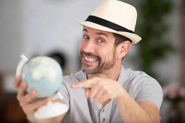 Young Cheerful Man Casual Clothes Pointing Globe — Stock Photo, Image