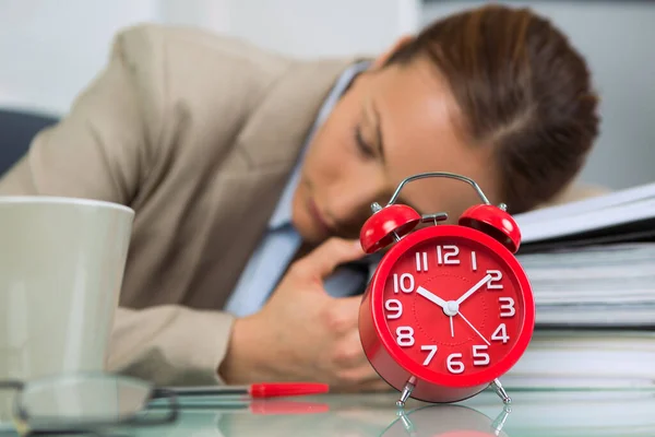 Woman Asleep Office Desk Alarm Clock Foreground — Stock Photo, Image
