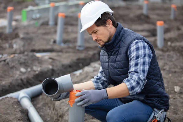 Plumber Fixing Sewerage Pipe Construction Site — Stock Photo, Image