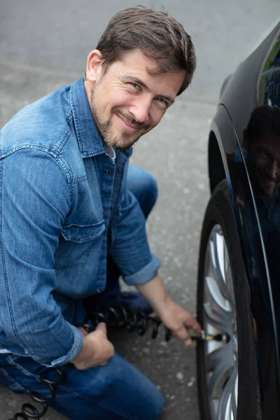 Adam Arabasının Lastiğini Şişiriyor — Stok fotoğraf