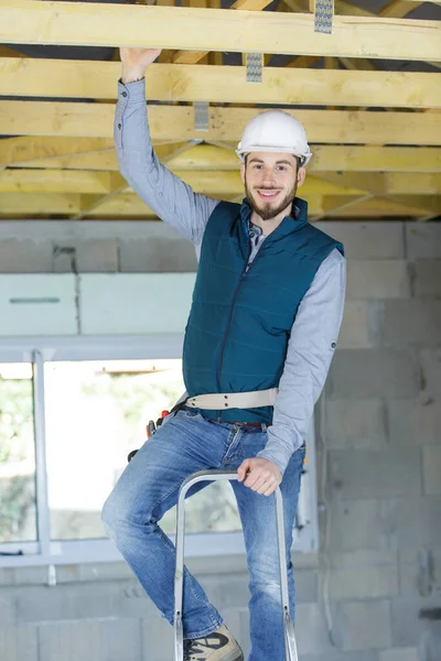 Jovem Construtor Escada Rolante Segurando Viga Telhado — Fotografia de Stock
