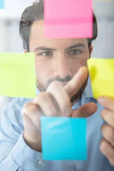 Businessman Studying Reminder Notes Window — Stock Photo, Image