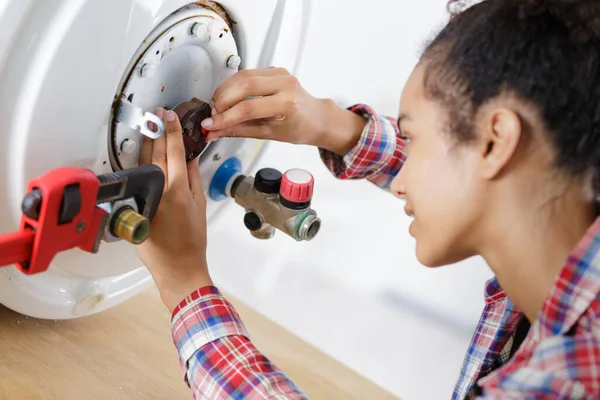Young Female Worker Installing Electric Boiler Bathroom — Stock Photo, Image