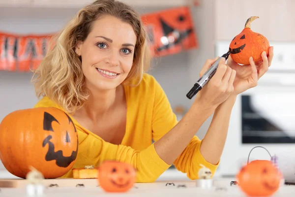 Glückliche Frau Zeichnet Gruseligen Kürbis Für Halloween Party — Stockfoto