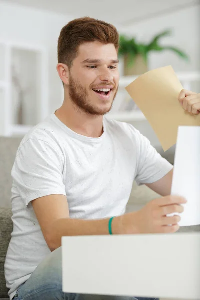 Young Man Reading Letter Joyful Expression — Stock Photo, Image