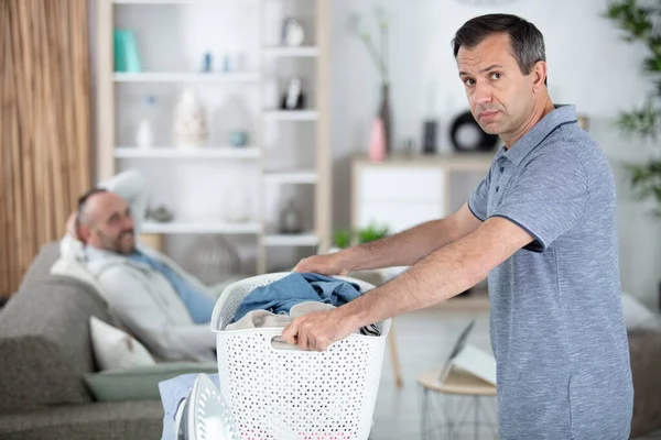 exhausted man with laundry basket