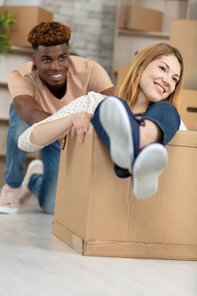 Happy Couple Having Fun Riding Cardboard Boxes — Stock Photo, Image