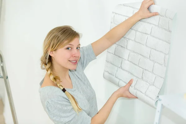 Woman Putting Wallpaper — Stock Photo, Image