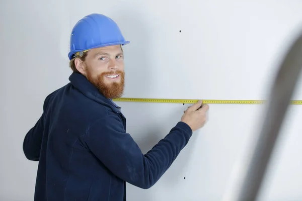 Workman Holding Tape Measure Wall — Stock Photo, Image