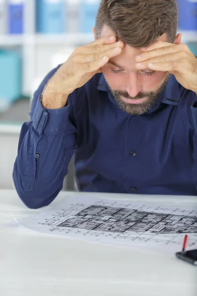 stressed male architect under pressure in office