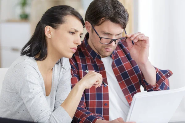 couple reading the small print in a printed contract