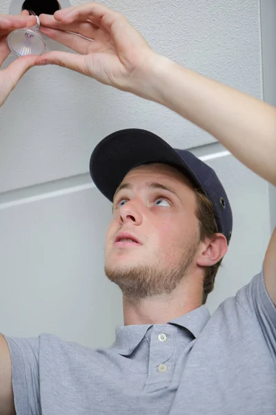 Young Male Electrician Fixing Light Ceiling — Stock Photo, Image