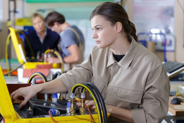 young people in technical vocational training with teacher