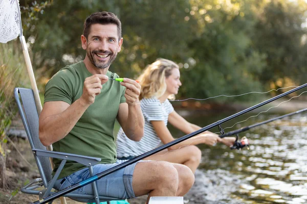 lovely young couple enjoying fishing