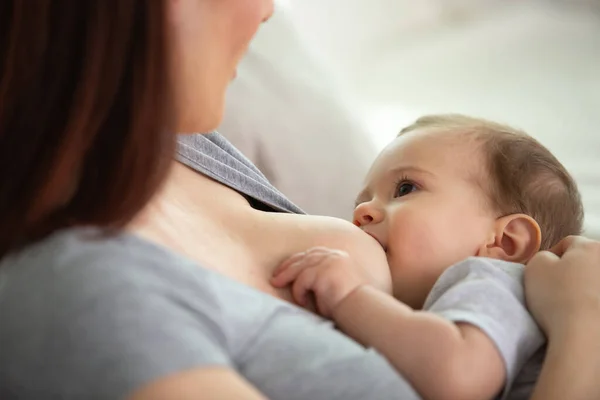 stock image mother breastfeeding and hugging baby