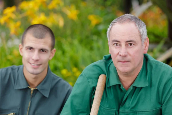 two happy gardeners looking at camera