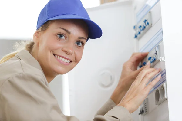 Happy Woman Inspecting Fuse Board — Stock Photo, Image
