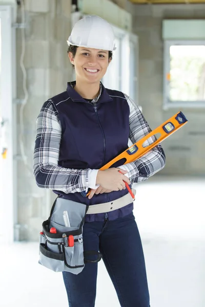 young smiling woman working with a spirit level