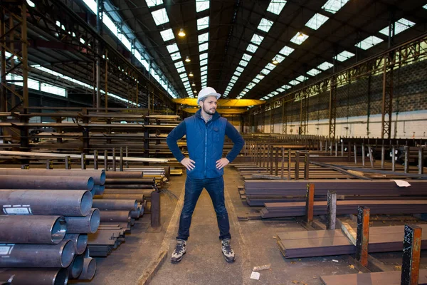 man standing alone and confidently in his workshop