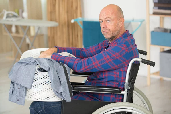 Upset Disabled Man Has Laundry Task — Photo