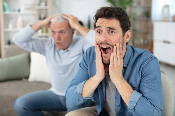 two generations of men frustrated by favourite football team failure