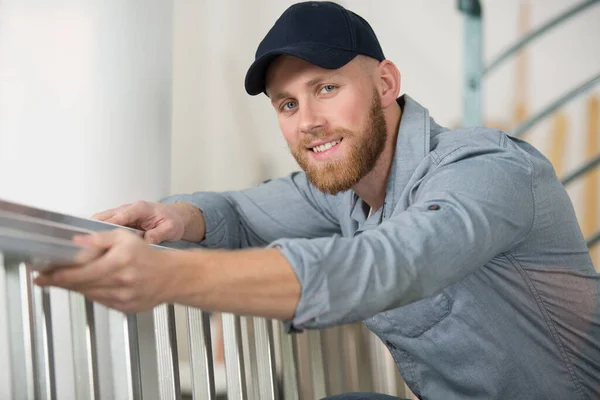 Young Smiling Carpenter Manufactures Stairs — Stock Photo, Image
