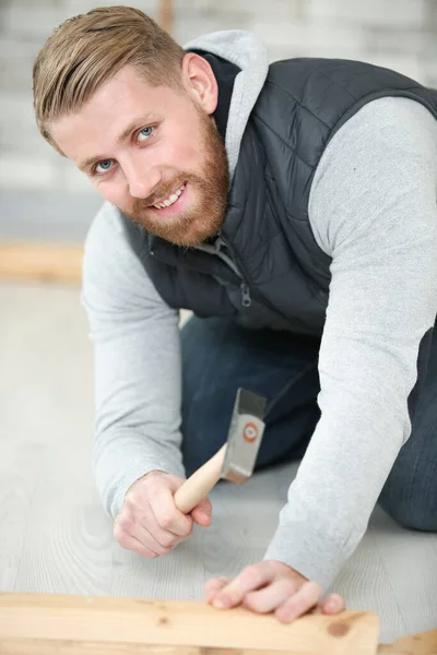 Handsome Guy Hammering Nail Wood Plank — Zdjęcie stockowe