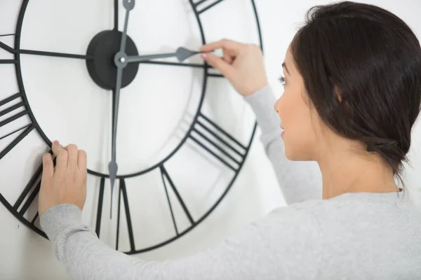 Woman Setting Time Wall Clock — Foto de Stock